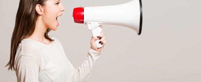 Women talking through a loud speaker