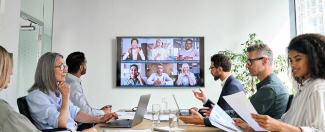 People in a meeting room attending zoom meeting