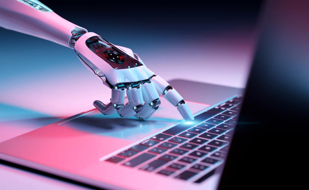 Robotic hand pressing a key on a laptop keyboard