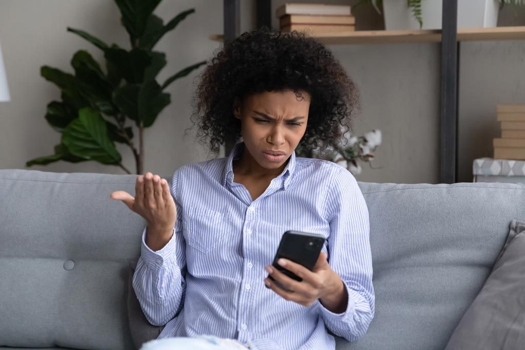 Woman disappointed looking at the phone