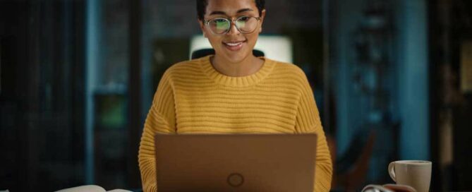 Woman looking at the laptop screen and smiling